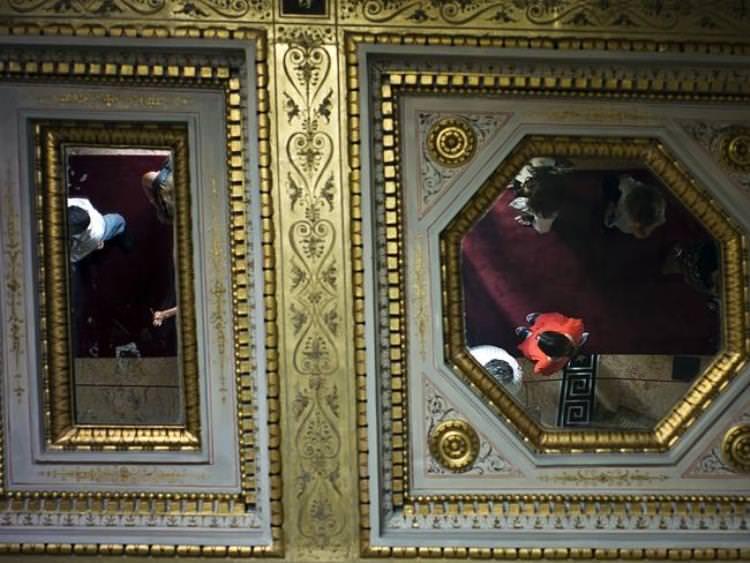 Visitors are reflected in the mirror-patched ceilings. Source: AP 