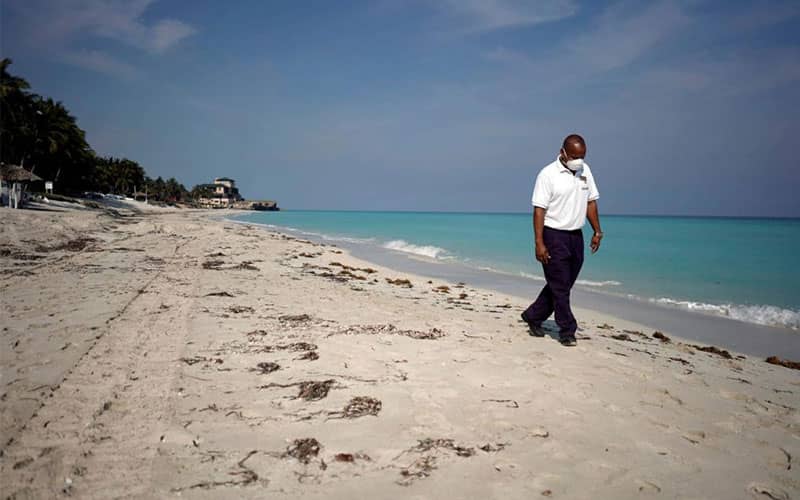گردشگری که به تنهایی در ساحل قدم می زند
