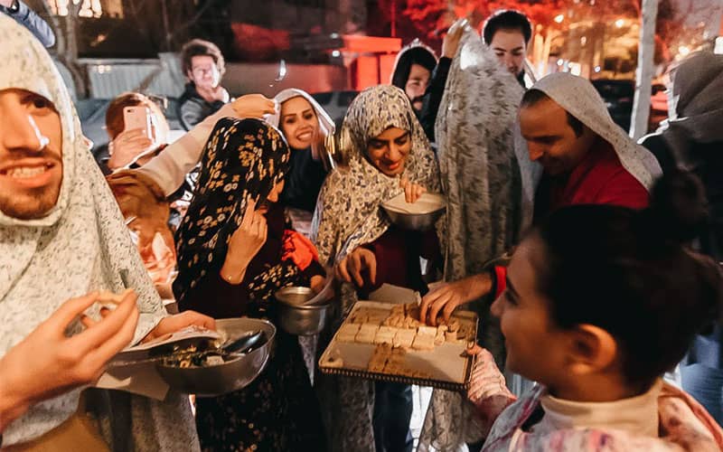 جوانانی که در شب چهارشنبه سوری چادر پوشیده و شیرینی می خورند