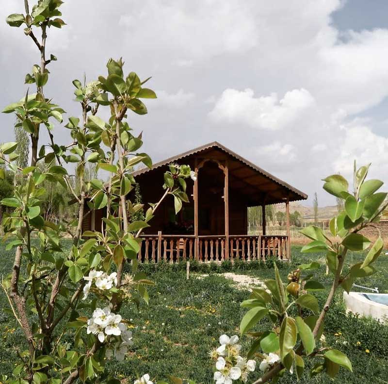 اقامتگاه بومگردب سیمین کنار از میان بوته گیاهان از نمای دور