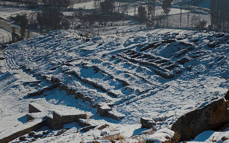 تپه ای برفی با بقایای دیوارهای تاریخی