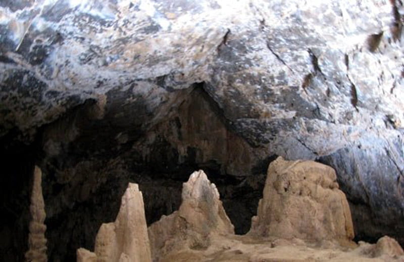 تصویری از دهانه ورودی غار شگفت یزدان با قندیل های آهکی