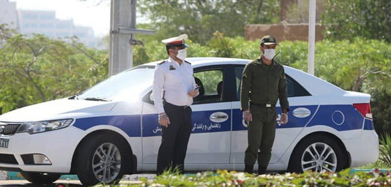 پلیس و سرباز راهنمایی و رانندگی در جزیره کیش مقابل ماشین راهنمایی و رانندگی، منبع عکس: خبر آنلاین، عکاس نامشخص