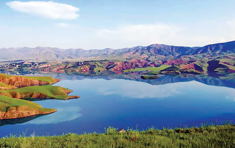 دریاچه سد طالقانی در جوار کوهستان‌های سبز و شهر طالقان