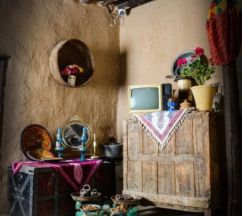 تزئینات سنتی با تلویزیون و آینه شمعدان در اقامتگاه بومگردی آق بجی و دده