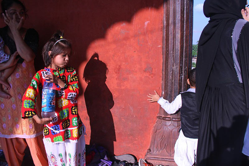زن هندو و دختربچه‌ای با لباس رنگی در مسجد جامع دهلی