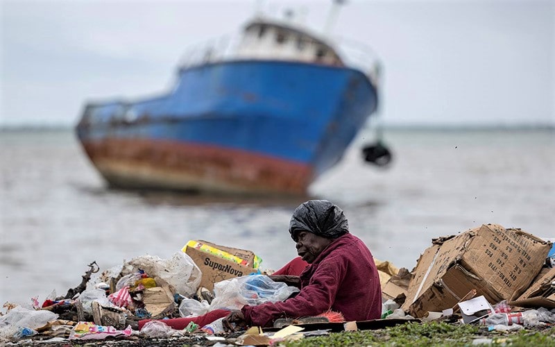 زن زباله گرد در کنار دریا